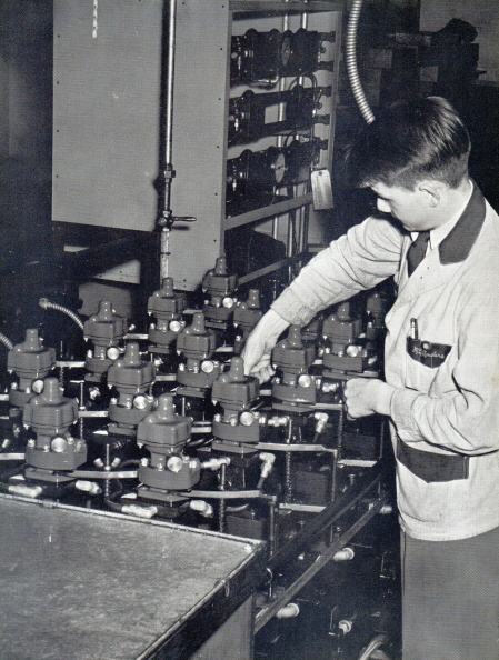 A Woodward worker pressure testing propeller governors manufactured for the Hamilton Standard Company's exclusive contract during World War two.